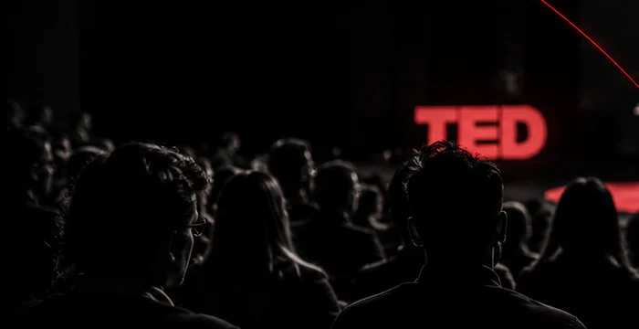 The audience during a talk, lit red