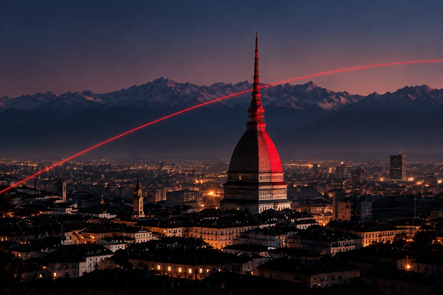 Turin at dusk: the Mole Antonelliana lit red against the Alps