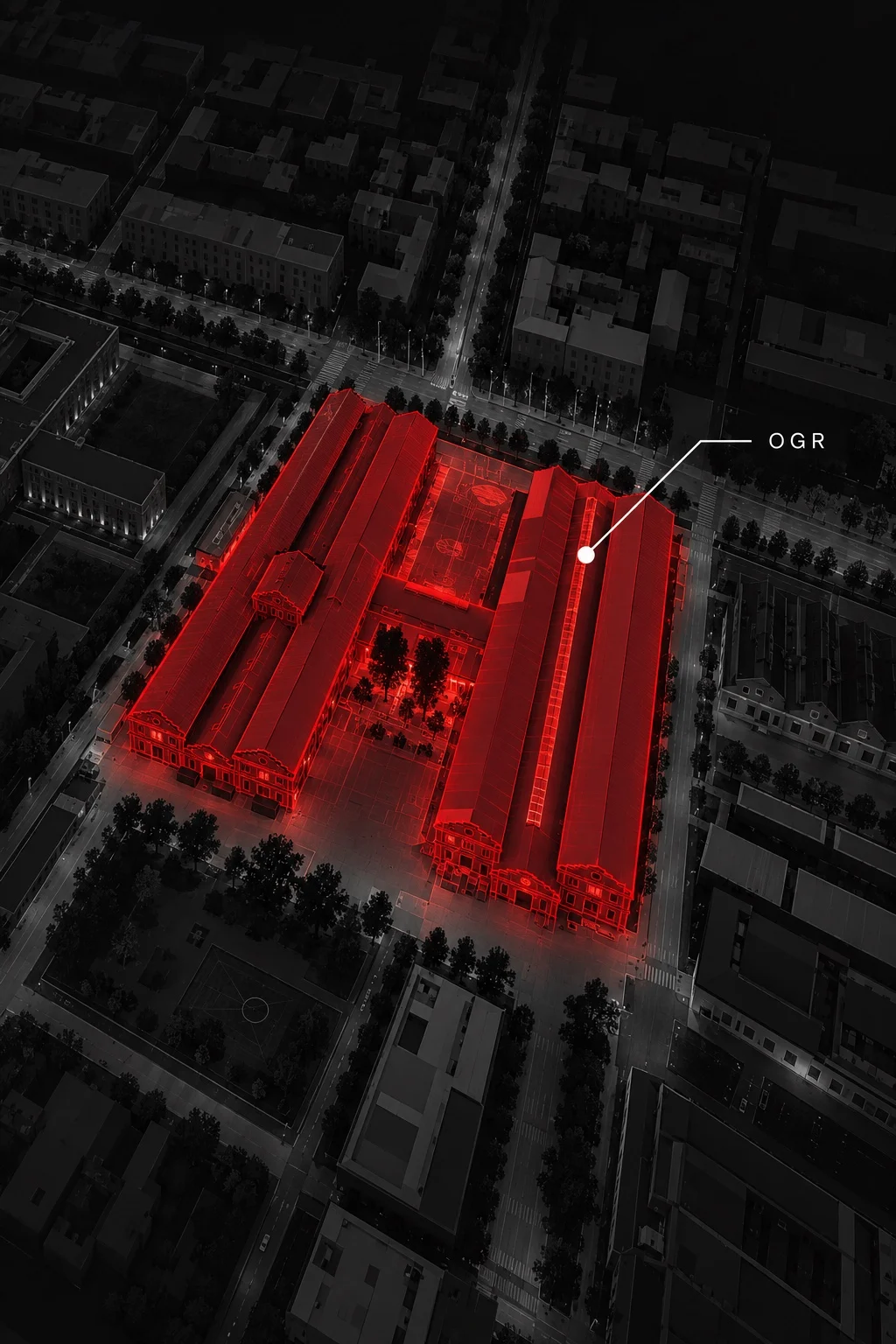 Aerial view of OGR Torino at night, the former railway workshops highlighted in red